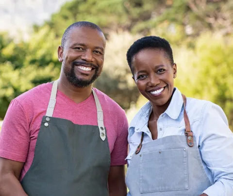 Two farmers standing next to each other.
